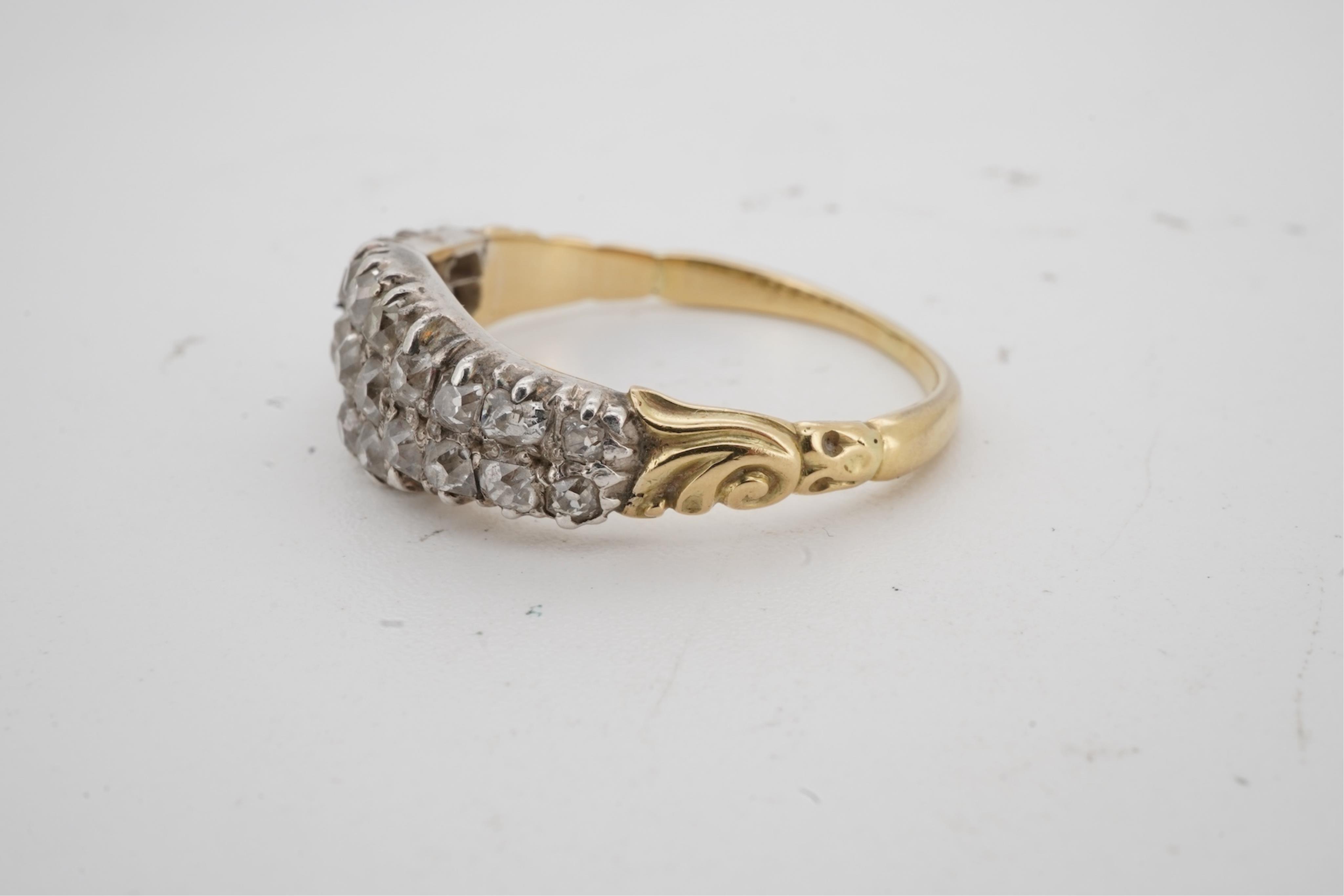 A diamond half-hoop ring, mid 19th century, pavé-set to the front with three rows of cushion-shaped diamonds totalling approximately 0.80 carats, to foliate carved shoulders, mounted in gold, size O, gross weight approxi